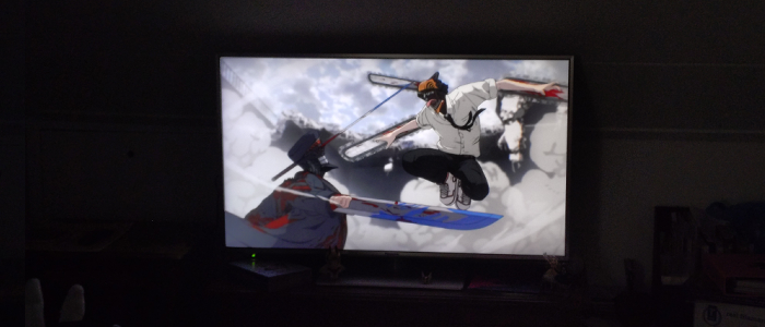 A picture of a TV setup with Chainsaw Man playing