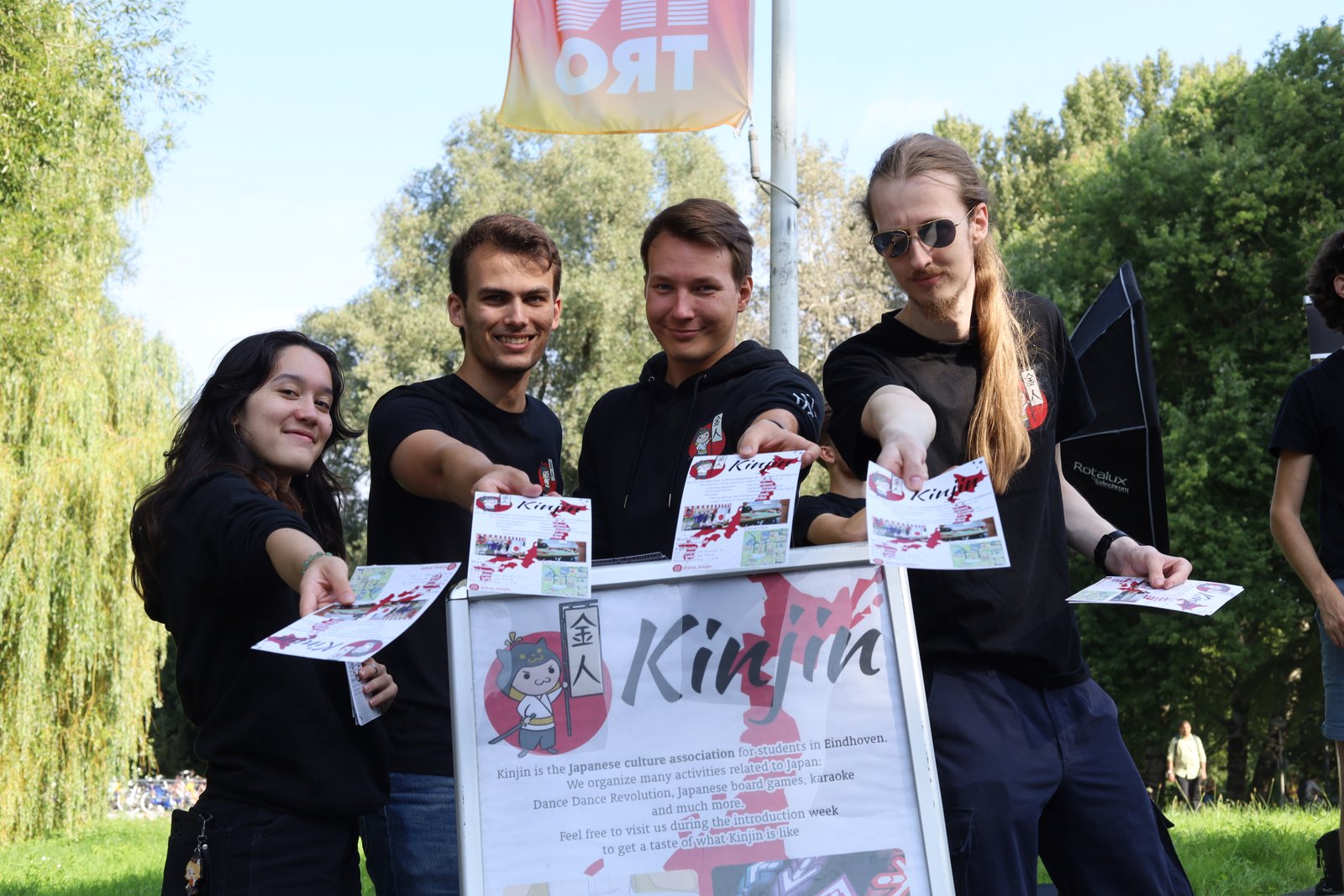 Kinjin members holding out flyers