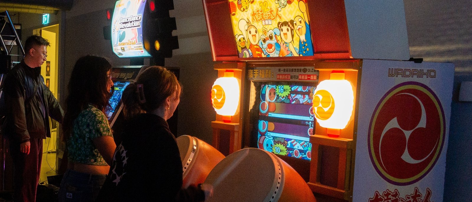 A person playing "Taiko no Tatsujin" on an arcade machine
